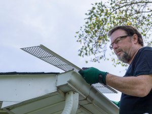 Auburn roofing contractor installs gutter guards on gutters
