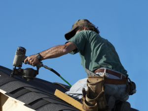 Auburn roofing experts at work on a sunny day.
